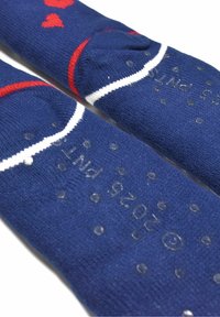 Blue socks with red heart patterns, white stripes, and rubberized grip dots on the soles for traction. Soft knit texture.