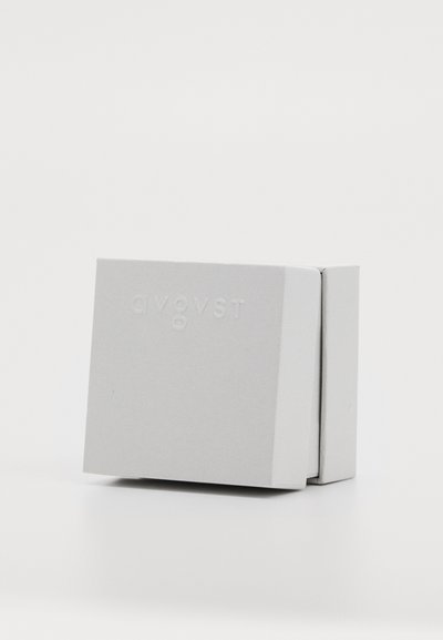 Gray rectangular box with a textured surface, featuring embossed letters "AVG VST" on the front. Compact and minimalistic design.