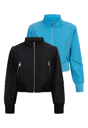 Deux vestes légères, une noire et une bleue, chacune avec une fermeture éclair à l'avant, des poches zippées et un col montant, présentées sur un fond blanc.
