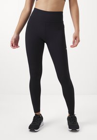 Black high-waisted leggings made of stretchy material, featuring a smooth texture and a fitted cut. Pair with black athletic shoes.
