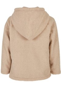 Beige, flauschige Jacke mit Kapuze, strukturiertem Finish, senkbaren Schultern und lässiger Passform. Verfügbar mit einer breiten Kapuze und aus weichem, warmem Material.