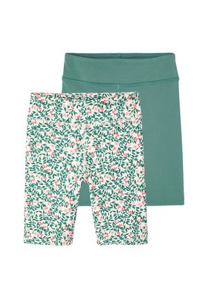 Two pairs of fitted shorts, one solid teal and one white with green leaf and pink floral pattern, flat laid on a white background.