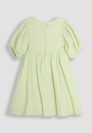 Light green cotton dress with short puff sleeves, textured fabric, round neckline, and a row of buttons along the back. Flared skirt design.