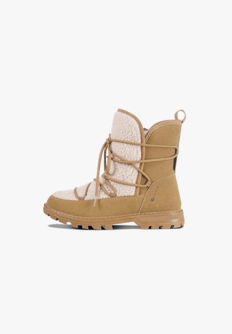 Tan ankle boots with a soft white fleece upper, lacing detail, and sturdy rubber soles featuring textured tread for grip.