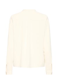 Cream-colored long-sleeve shirt with a straight hem, buttoned cuffs, and a back pleat for ease. Made from smooth, lightweight fabric.