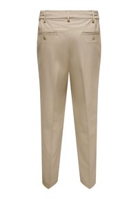 Pantalon beige sur mesure avec une texture lisse, doté d'une ceinture élastique, de deux poches arrière et d'une coupe slim effilée.