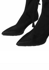 Czarne botki za kostkę z spiczastymi noskami, tekstylną cholewką i cienkimi obcasami w stylu stiletto. Posiadają boczny zamek błyskawiczny i gładką fakturę na powierzchni.