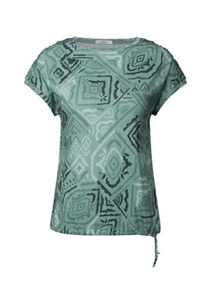 Lyhythihainen paita vaaleanvihreästä kankaasta, jossa on geometrisia mustia kuvioita, pyöreä pääntie ja säädettävä naru vyötäröllä.