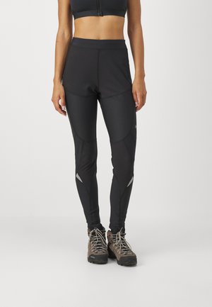 Leggings neri a vita alta con una texture liscia e un design attillato. Presentano accenti riflettenti a contrasto sulle gambe.