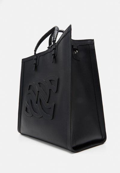 Sac à main en cuir noir de forme structurée, arborant un logo en relief bien visible, des accents de poignées tissées et des détails de couture subtils.