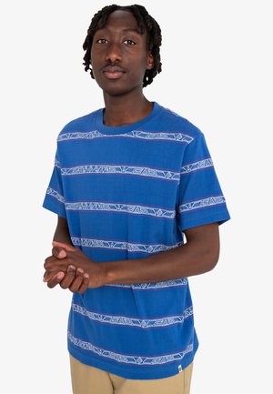 Blue short-sleeve t-shirt with horizontal white and red tribal pattern stripes. Soft fabric, crew neckline, relaxed fit.