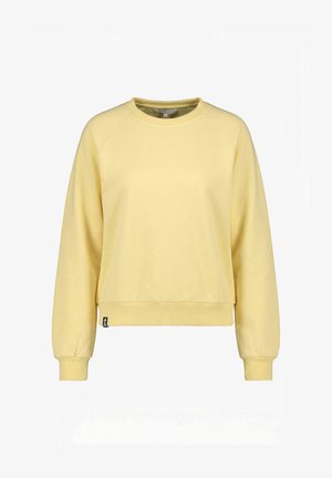 Sweat-shirt à manches longues jaune clair avec col rond, poignets et ourlet côtelés, avec une petite étiquette noire de la marque en bas à gauche.