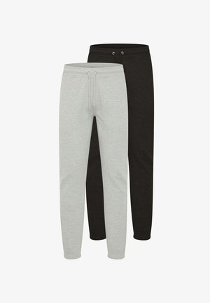 To par med joggebukser: en grå og en svart. Begge har elastisk midjebånd, snøring og smale ben. Myk stofftekstur.