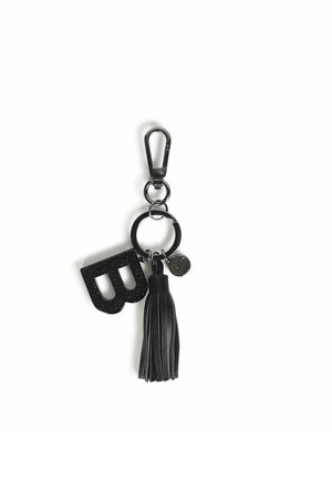 Portachiavi nero con una forma 'B' glitterata, un pon-pon in pelle e un gancio metallico. Materiali testurizzati e accenti lucidi caratterizzano il design.