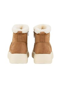 Braune Wildleder-Stiefeletten mit einem plüschigen weißen Fleece-Kragen, ausgestattet mit einem seitlichen Reißverschluss und einer dicken, cremefarbenen Gummisohle.