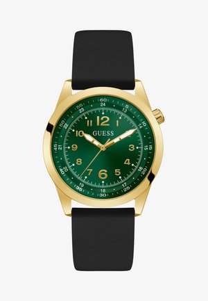 Orologio dorato con quadrante verde, cinturino in gomma nera, grandi marcatori numerici e due lancette. Presenta una lunetta texturizzata e il logo del marchio.