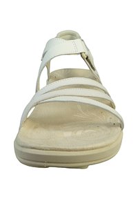 White sandal with three horizontal straps, adjustable ankle strap, cushioned footbed, and textured sole featuring floral pattern.