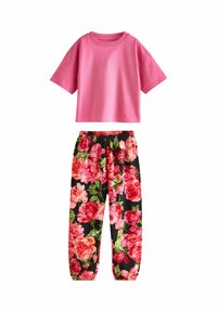 Two-piece set featuring a pink cotton cropped t-shirt and black joggers with a vibrant floral pattern in pink and green.