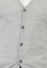 Lichtgrijze cardigan van zacht gebreid materiaal met een V-halsontwerp, zes ronde grijze knopen en een subtiele textuur.