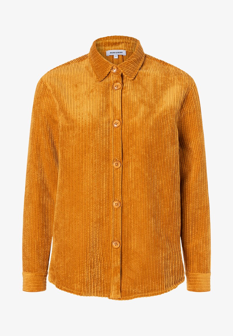 Corduroy shirt in mustard yellow, featuring a collar, button front, and long sleeves with ribbed texture and five wooden buttons.