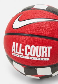 Red basketball with textured surface, black and white accents, and a checkered pattern at the bottom. Features "ALL-COURT" branding.