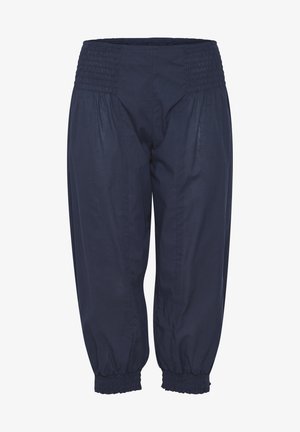 Tumedast puuvillased püksid elastse vöökoha ja mansettidega, millel on lõdvestatud, kitsenev lõige ja kogutud tekstuur vööjoonel.