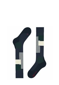 Marine sokken met geometrische patronen in groen en roomkleur. Bevat strepen en vaste vormen. Gemaakt van een ademende stof.