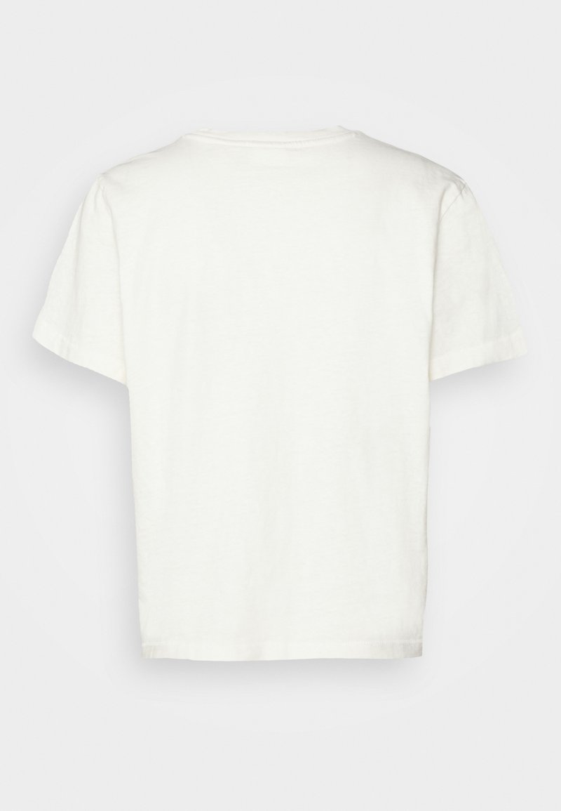 Camiseta de manga corta y cuello redondo en algodón beige claro con un corte relajado y una textura suave. Sin gráficos o adornos visibles.