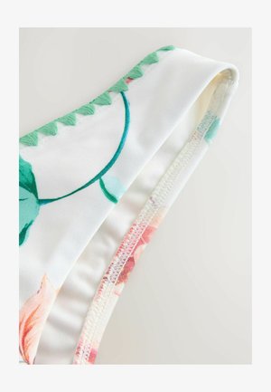 Bloemdruk bikini-top van witte stof, met groene geborduurde accenten langs de rand en een zachte, rekbare textuur.