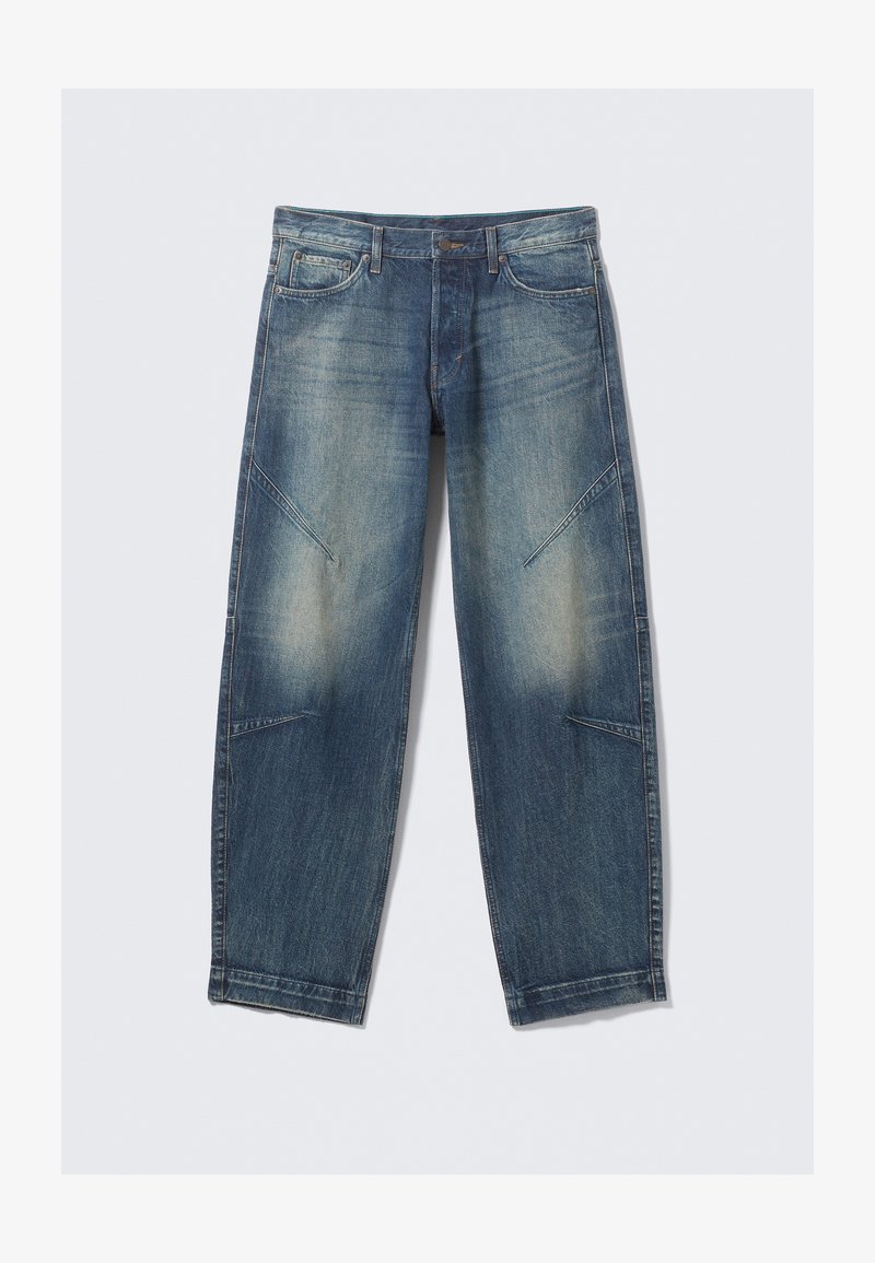 Light blue denim jeans with a loose fit, featuring faded spots, frontal pockets, and diagonal seam accents. Straight leg design.