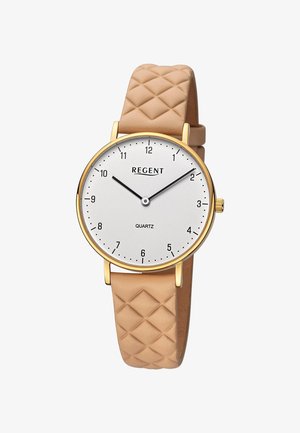 Montre à quartz avec un cadran blanc, des accents dorés, des marqueurs d'heure noirs et un bracelet en silicone beige texturé.
