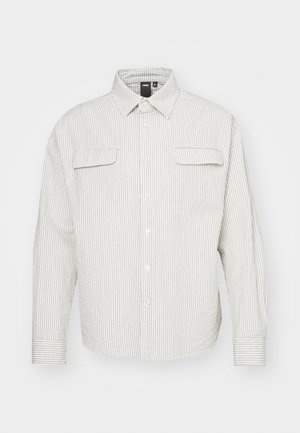 Light striped shirt featuring a button-up front, collar, and two chest pockets. Made of fabric with a textured finish.