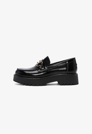 Black leather loafer with a chunky rubber sole, featuring a decorative gold hardware detail on the vamp and a smooth, glossy finish.