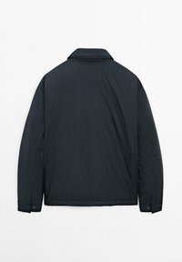 Dark, insulated jacket with a collar, long sleeves, and buttoned cuffs. Smooth texture and minimalist design. Plain back view.