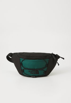 Black and teal waist bag with a rounded shape, featuring a textured front, logo detail, and adjustable strap for secure carrying.