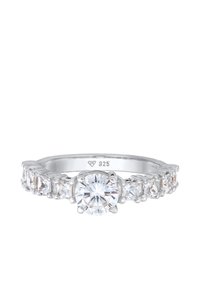 Sterling silver ring featuring a central round cut clear stone, flanked by rectangular cut stones, with a polished finish. Marked "925."