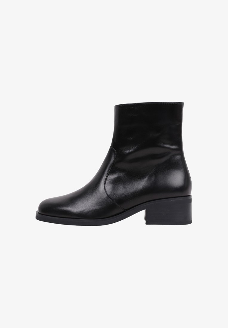 Black leather ankle boot with a rounded toe, minimal stitching, and a low block heel. Smooth texture with a shiny finish.