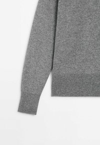 Gray knitted sweater with a soft texture, featuring a round neck and ribbed cuffs and hem. Simple, seamless design.