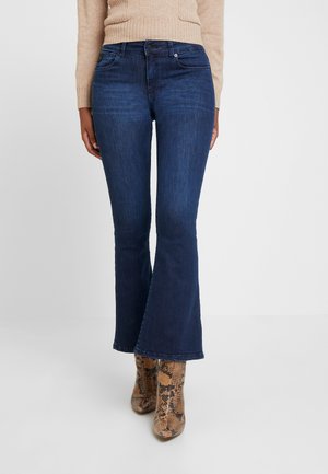 Dark blue flared jeans with a mid-rise waist, made of denim. Features a classic five-pocket design and subtle fading at the thighs.