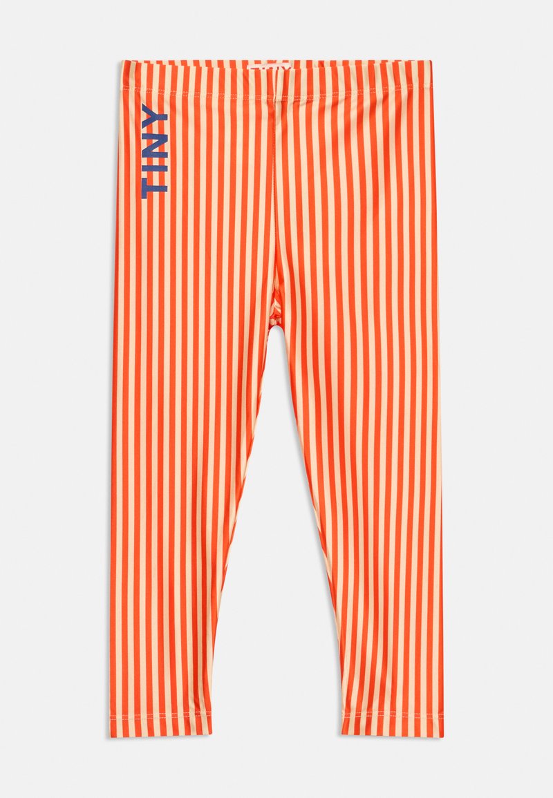 Leggings à rayures verticales orange et beige avec "TINY" imprimé en bleu sur la cuisse supérieure gauche.