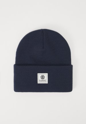 Navy blue knit beanie with a folded cuff, featuring a square patch with the word "ELEMENT" and a circular logo. Soft texture.