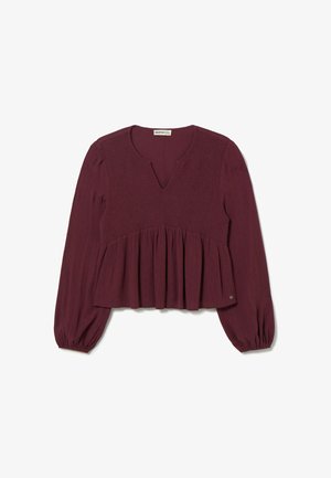 Blusa burdeos con escote en V, cuerpo fruncido y peplum acampanado. Mangas largas con puños elásticos, hecha de una tela texturizada.