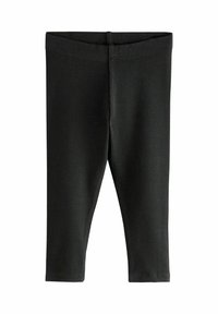 Leggings noirs côtelés avec une taille mi-haute, présentant une texture lisse et un design ajusté, se terminant juste au-dessus des chevilles.