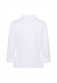 Chemise blanche à manches longues avec col vue de dos, présentant des coutures ajustées et des poignets cintrés.