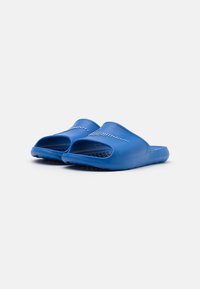 Blue molded plastic slides with an open toe design, featuring a textured upper and perforated accents for breathability.