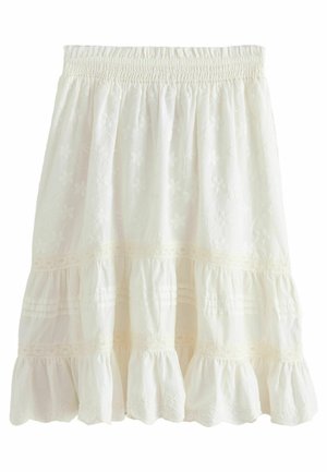 Jupe blanche longueur genoux avec taille smockée, broderie florale, bordure en dentelle et ourlet volanté.