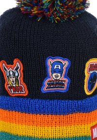 Knitted beanie with a navy top featuring a multicolored striped band. Features embroidered superhero patches: Thor, Captain America, Black Panther, and colorful pom-pom.