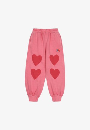 Rozā sporta bikses ar trim lielām sarkanu sirdsapziņas apdruku uz priekšpuses, elastīgu jostu, piekļuves nogriežņiem un sānu kabatām. Snieguma logo uz gurniem.