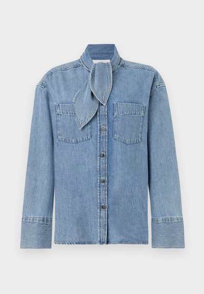 Light blue denim shirt with long sleeves, two chest pockets, button closure, and a matching scarf detail at the collar.