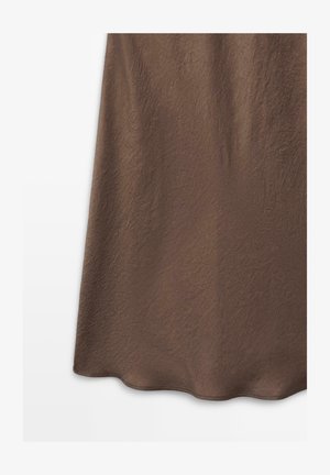 Brown skirt with a subtle textured pattern, shown hanging against a white background, highlighting fabric details and hemline.